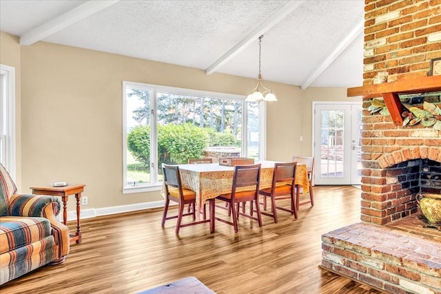 183 Prairie Plains Rd, Hillsboro, TN 37342 - dining space with light wood-type flooring, a textured ceiling, a chandelier, and baseboards