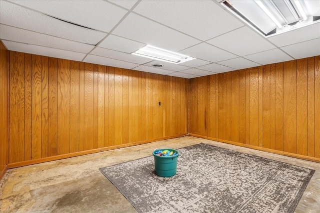 183 Prairie Plains Rd, Hillsboro, TN 37342 - spare room featuring a drop ceiling, wood walls, concrete floors, and baseboards