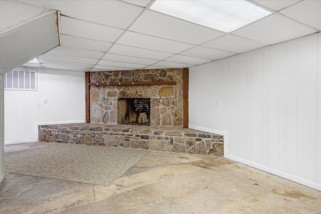 183 Prairie Plains Rd, Hillsboro, TN 37342 - unfurnished living room featuring a drop ceiling, a stone fireplace, and baseboards