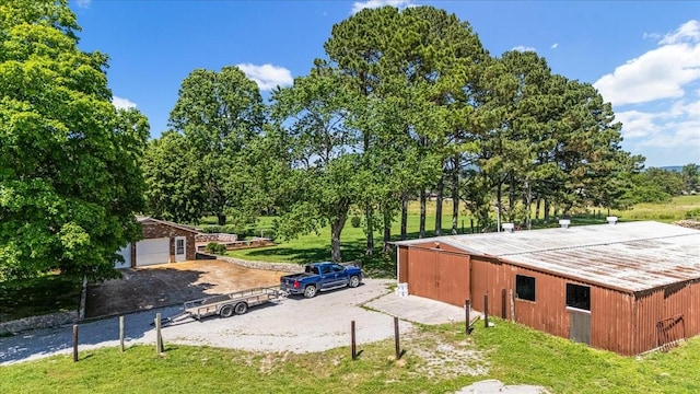 183 Prairie Plains Rd, Hillsboro, TN 37342 - view of property exterior featuring an outdoor structure, a garage, and a pole building