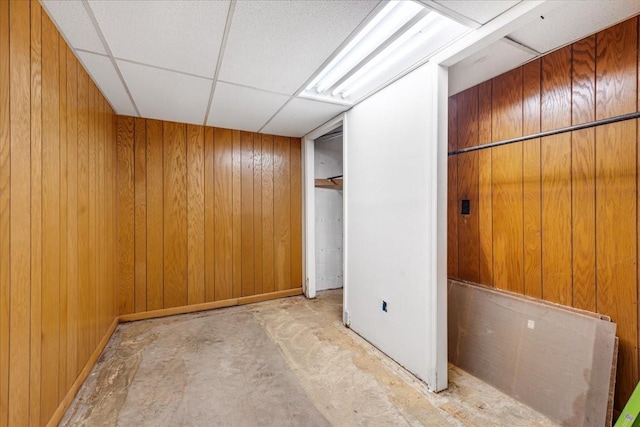 183 Prairie Plains Rd, Hillsboro, TN 37342 - unfurnished bedroom featuring wood walls, a paneled ceiling, and concrete flooring