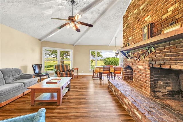 183 Prairie Plains Rd, Hillsboro, TN 37342 - living area featuring a textured ceiling, wood finished floors, a brick fireplace, a ceiling fan, and baseboards