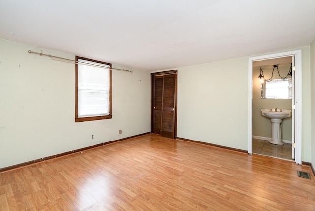 942 Youngs Ln, Nashville, TN 37207 - unfurnished bedroom with light wood-style floors, baseboards, and ensuite bathroom