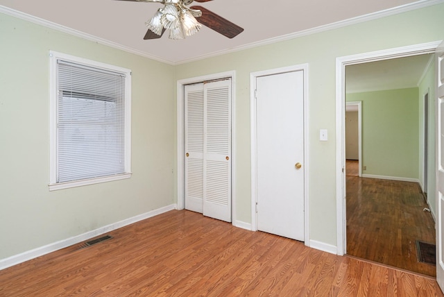 942 Youngs Ln, Nashville, TN 37207 - unfurnished bedroom with ornamental molding, light wood finished floors, baseboards, and a ceiling fan