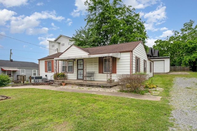 942 Youngs Ln, Nashville, TN 37207 - view of front of property with covered porch, a front yard, roof with shingles, and a detached garage