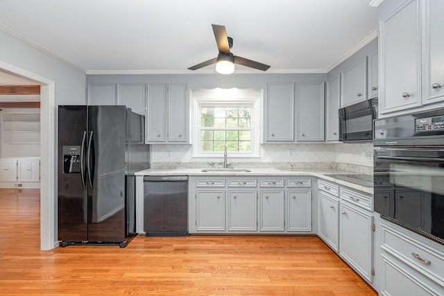 463 Mckaig Rd, Murfreesboro, TN 37127 - kitchen with black appliances, a sink, backsplash, crown molding, and light wood-style flooring