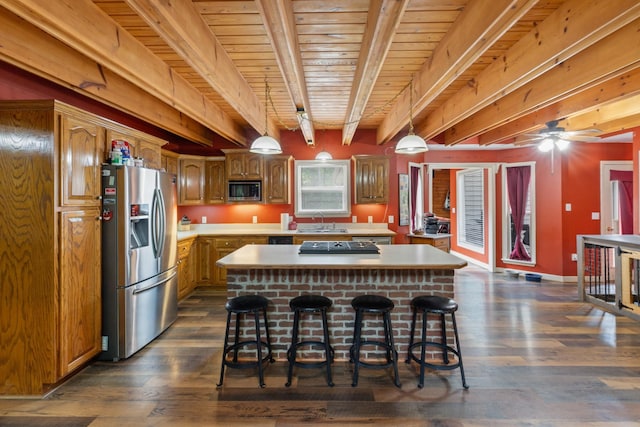 4357 Old Blacktop Rd, Mc Ewen, TN 37101 - kitchen with stainless steel appliances, light countertops, a kitchen island, dark wood-style flooring, and wood ceiling with exposed beams