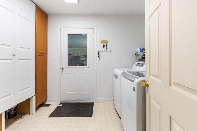 4357 Old Blacktop Rd, Mc Ewen, TN 37101 - laundry room with independent washer and dryer, cabinet space, light floors, and baseboards