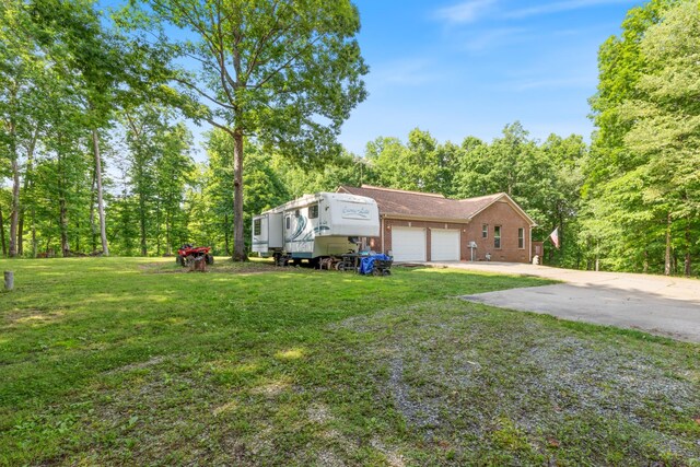 4357 Old Blacktop Rd, Mc Ewen, TN 37101 - view of front of home featuring an attached garage, a front lawn, driveway, and brick siding