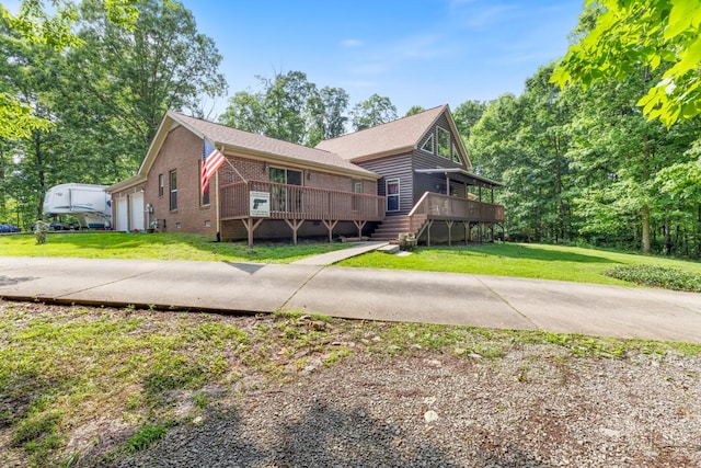 4357 Old Blacktop Rd, Mc Ewen, TN 37101 - view of front of home featuring brick siding, a wooden deck, and a front yard