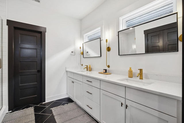 537B Stevenson St, Nashville, TN 37209 - bathroom featuring double vanity, baseboards, tile patterned flooring, and a shower