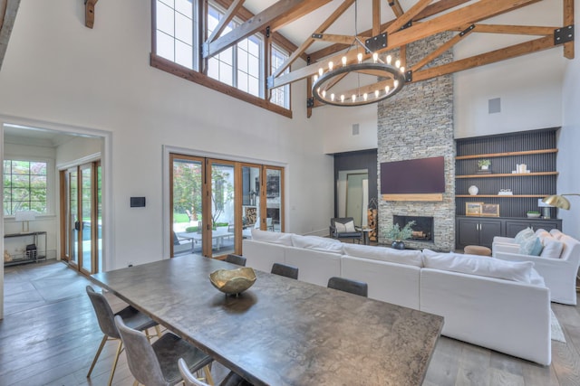 1021 Julian Way, Murfreesboro, TN 37128 - dining room featuring high vaulted ceiling, french doors, plenty of natural light, a stone fireplace, and a chandelier