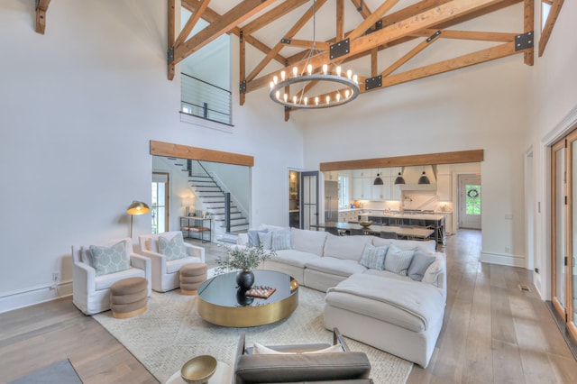 1021 Julian Way, Murfreesboro, TN 37128 - living room with high vaulted ceiling, a chandelier, stairs, hardwood / wood-style floors, and beamed ceiling