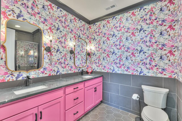 1021 Julian Way, Murfreesboro, TN 37128 - full bathroom featuring wallpapered walls, double vanity, tile walls, a stall shower, and a wainscoted wall