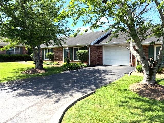 1130 Horse Mountain Rd Unit E, Shelbyville, TN 37160 - single story home with an attached garage, brick siding, asphalt driveway, and a front lawn