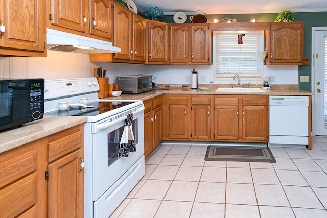 1130 Horse Mountain Rd Unit E, Shelbyville, TN 37160 - kitchen with white appliances, under cabinet range hood, a sink, brown cabinetry, and ornamental molding