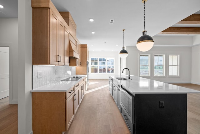 24 Fawn Mdws, Clarksville, TN 37043 - kitchen featuring a sink, light wood-style flooring, light countertops, backsplash, and appliances with stainless steel finishes