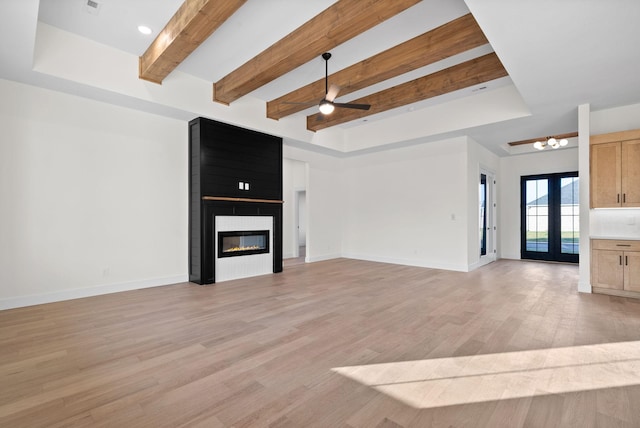 24 Fawn Mdws, Clarksville, TN 37043 - unfurnished living room with beam ceiling, light wood-style flooring, ceiling fan, a fireplace, and baseboards