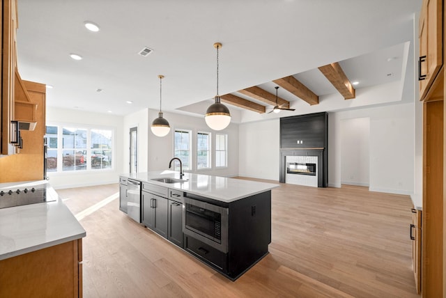24 Fawn Mdws, Clarksville, TN 37043 - kitchen featuring appliances with stainless steel finishes, a sink, dark cabinets, light wood-style floors, and baseboards