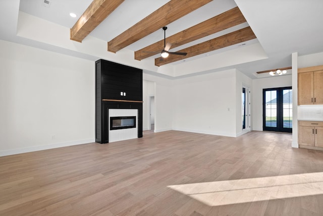 24 Fawn Mdws, Clarksville, TN 37043 - unfurnished living room with light wood finished floors, beam ceiling, ceiling fan, a fireplace, and baseboards