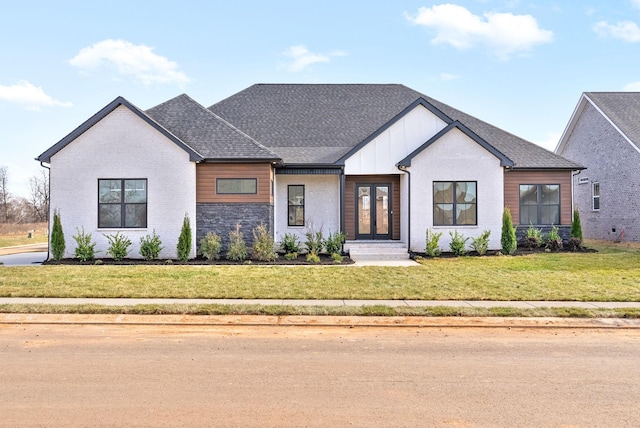 24 Fawn Mdws, Clarksville, TN 37043 - modern farmhouse with a front lawn, brick siding, board and batten siding, a shingled roof, and french doors