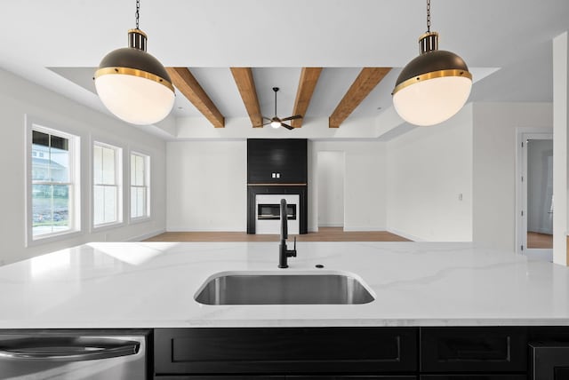 24 Fawn Mdws, Clarksville, TN 37043 - kitchen featuring open floor plan, a sink, stainless steel dishwasher, dark cabinets, and beamed ceiling