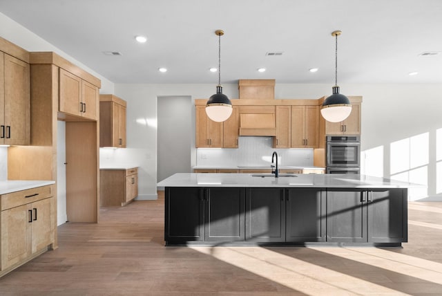 24 Fawn Mdws, Clarksville, TN 37043 - kitchen with a sink, light wood-style floors, decorative backsplash, light countertops, and a large island with sink
