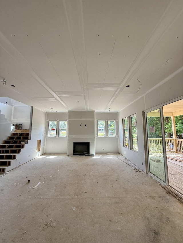 559 Watsonwood Dr, Nashville, TN 37211 - unfurnished living room featuring healthy amount of natural light, a fireplace, and stairway
