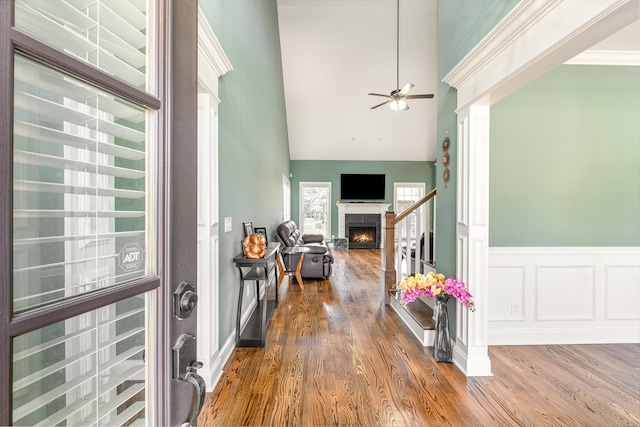 4423 Garcia Blvd, Murfreesboro, TN 37128 - foyer entrance with wood finished floors, a ceiling fan, a lit fireplace, a towering ceiling, and wainscoting