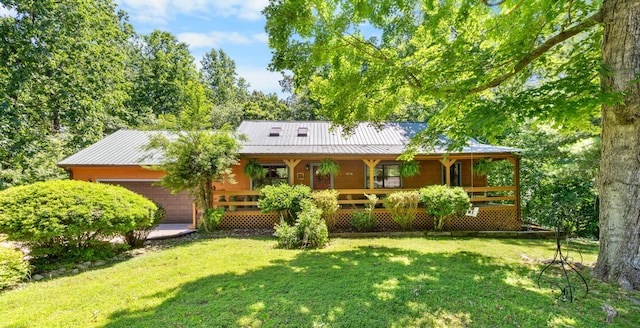123 Hidden Trl, Dover, TN 37058 - view of front of home featuring a garage, a porch, a front yard, and metal roof
