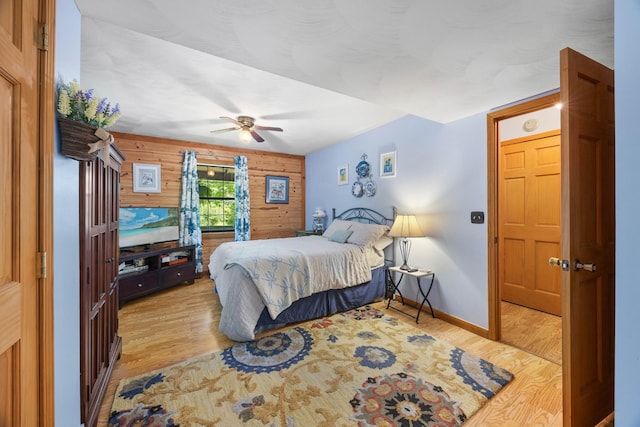 123 Hidden Trl, Dover, TN 37058 - bedroom with wooden walls, light wood-type flooring, baseboards, and a ceiling fan