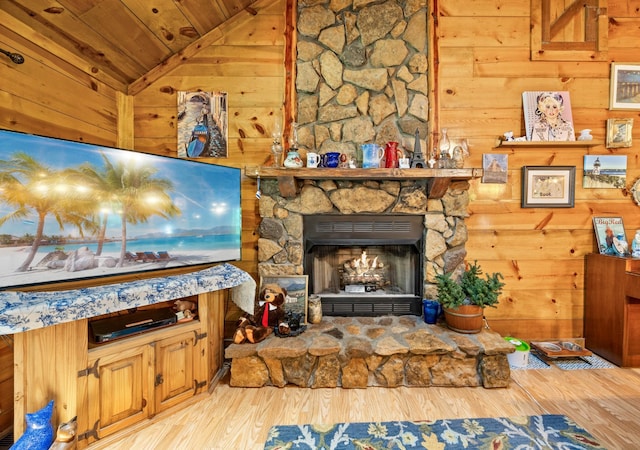 123 Hidden Trl, Dover, TN 37058 - living area featuring wooden ceiling, vaulted ceiling, wooden walls, wood finished floors, and a stone fireplace