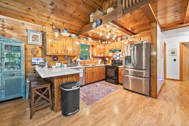 123 Hidden Trl, Dover, TN 37058 - kitchen with appliances with stainless steel finishes, wood ceiling with exposed beams, a peninsula, under cabinet range hood, and light wood-type flooring