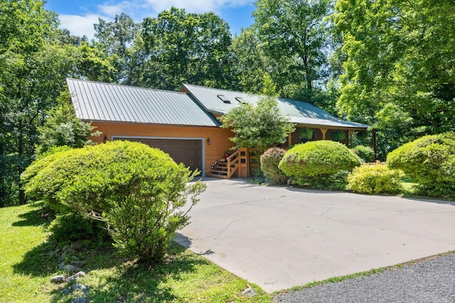 123 Hidden Trl, Dover, TN 37058 - view of front of property featuring an attached garage, driveway, and metal roof