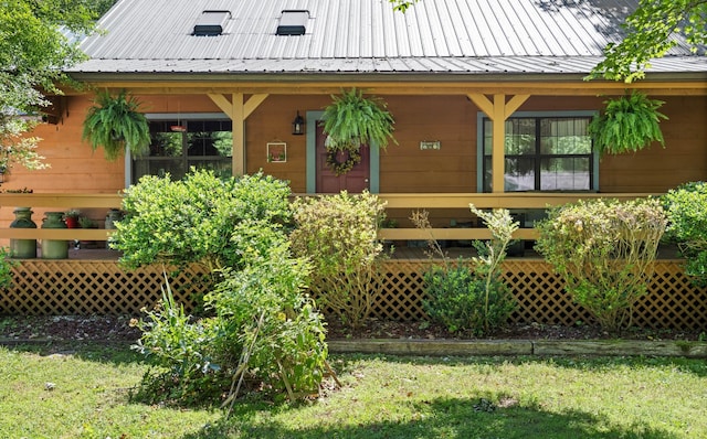 123 Hidden Trl, Dover, TN 37058 - doorway to property with a lawn, metal roof, and a porch
