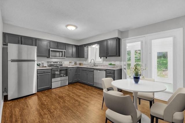 523 Williamsburg Dr, Nashville, TN 37214 - kitchen with stainless steel appliances, a sink, light countertops, gray cabinets, and a textured ceiling