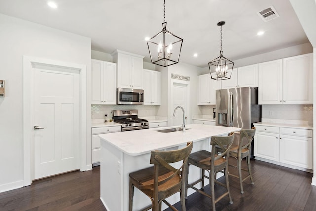 9420 Kaplan Ave, Brentwood, TN 37027 - kitchen featuring appliances with stainless steel finishes, a sink, a chandelier, decorative backsplash, and dark wood-style flooring
