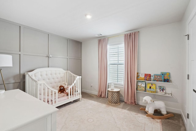 9420 Kaplan Ave, Brentwood, TN 37027 - bedroom featuring light carpet, a crib, a decorative wall, and baseboards
