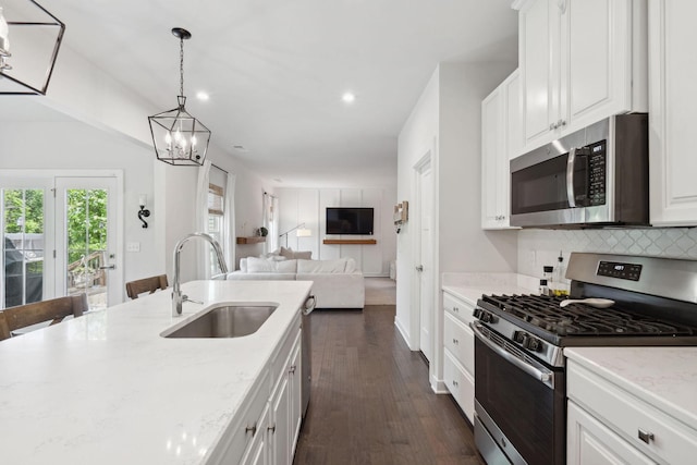 9420 Kaplan Ave, Brentwood, TN 37027 - kitchen with stainless steel appliances, a sink, a chandelier, backsplash, and white cabinetry