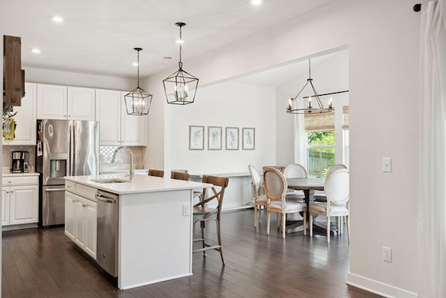 9420 Kaplan Ave, Brentwood, TN 37027 - kitchen featuring a chandelier, stainless steel appliances, a sink, dark wood finished floors, and recessed lighting