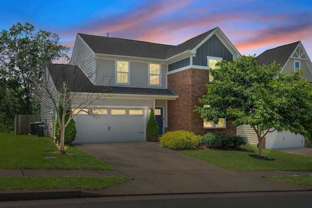 9420 Kaplan Ave, Brentwood, TN 37027 - view of front of home with board and batten siding, concrete driveway, cooling unit, a yard, and brick siding