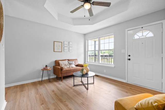 271 Golden Pond Ave, Oak Grove, KY 42262 - living room featuring a tray ceiling, light wood finished floors, baseboards, and a ceiling fan