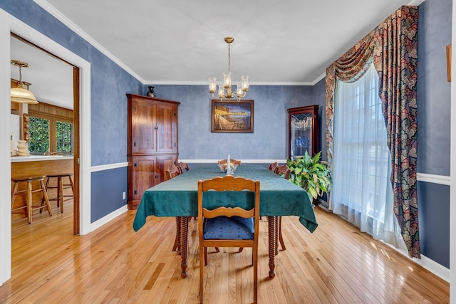 401 Ellington Dr, Franklin, TN 37064 - dining room with a chandelier, light wood-type flooring, baseboards, and ornamental molding