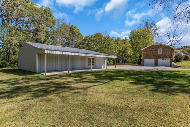 401 Ellington Dr, Franklin, TN 37064 - exterior space with a front lawn, an attached garage, an outbuilding, and driveway