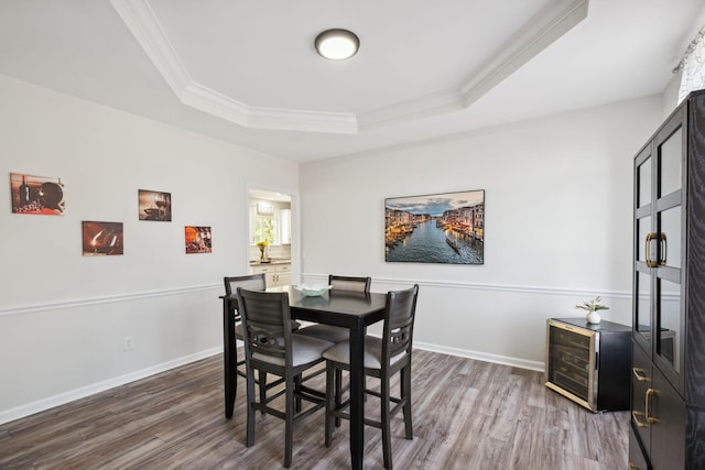 6961 Stone Run Dr, Nashville, TN 37211 - dining space with crown molding, wood finished floors, a tray ceiling, beverage cooler, and baseboards