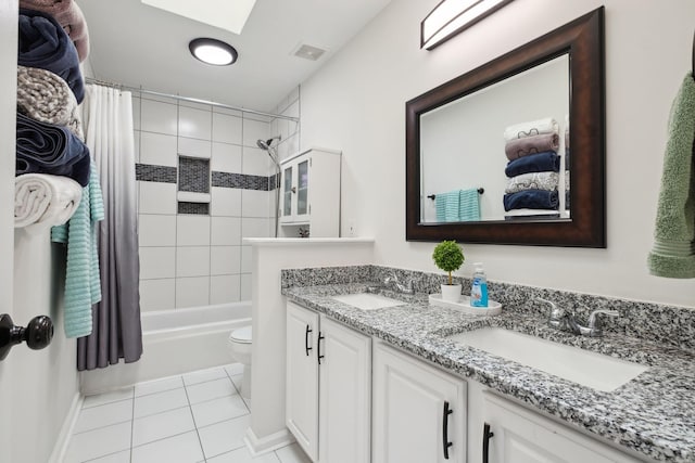 6961 Stone Run Dr, Nashville, TN 37211 - bathroom with double vanity, shower / bath combo with shower curtain, tile patterned flooring, toilet, and a skylight