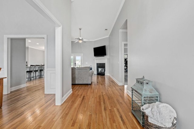2520 Pebblecreek Ln, Murfreesboro, TN 37130 - living room featuring crown molding, a ceiling fan, light wood-style floors, a tile fireplace, and a high ceiling
