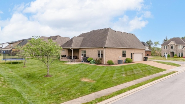 2520 Pebblecreek Ln, Murfreesboro, TN 37130 - view of front of home featuring a trampoline, concrete driveway, central AC, a garage, and a front yard