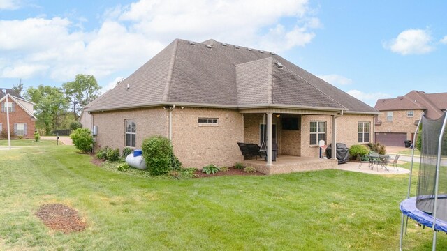 2520 Pebblecreek Ln, Murfreesboro, TN 37130 - back of property featuring a trampoline, a patio area, a yard, and roof with shingles