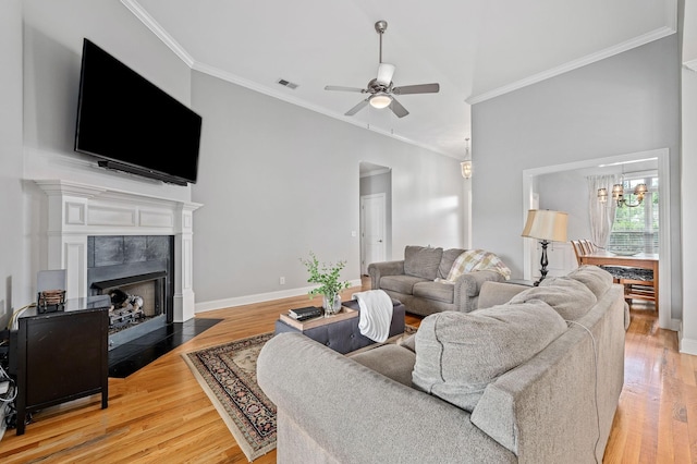 2520 Pebblecreek Ln, Murfreesboro, TN 37130 - living room with ornamental molding, ceiling fan, light wood finished floors, a fireplace with flush hearth, and a chandelier